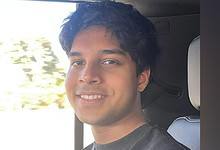 Image of Wayne Nash D’Souza, an 18-year-old Indian expat student and Dubai Duty-Free million-dollar draw winner, smiling inside a car.