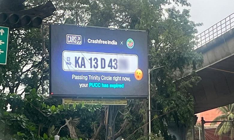 Billboard in Bengaluru displays traffic challans of cars passing by,