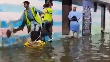The image shows GHMC officials extending help to those whose houses were flooded near Chaderghat, after around 10,000 cusecs of water was released from Osman Sagar and Himayat Sagar on Friday, September 26, 2025.