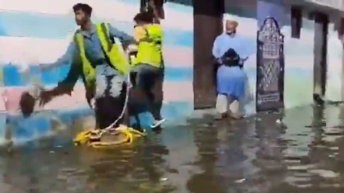 The image shows GHMC officials extending help to those whose houses were flooded near Chaderghat, after around 10,000 cusecs of water was released from Osman Sagar and Himayat Sagar on Friday, September 26, 2025.