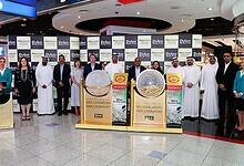Dubai Duty Free officials and participants pose during the Millennium Millionaire draw at Dubai International Airport.