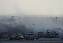 Israeli tanks covered in smoke after shelling