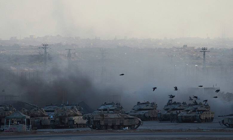 Israeli tanks covered in smoke after shelling