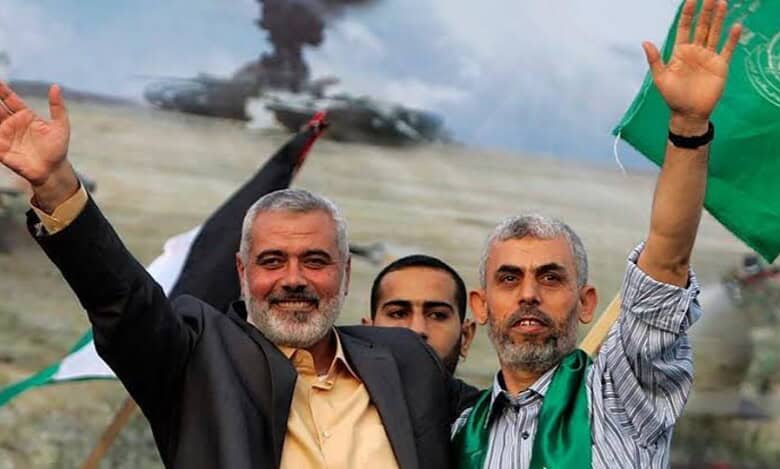 Ismail Haniyeh and Yahya Sinwar wave during a public gathering.