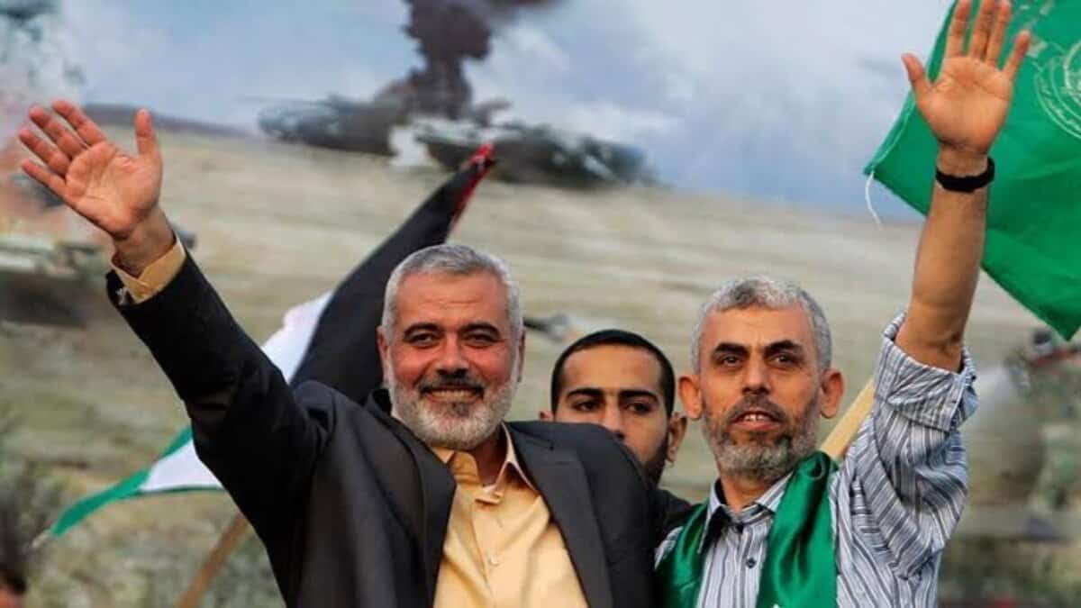 Ismail Haniyeh and Yahya Sinwar wave during a public gathering.
