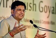 Piyush Goyal speaking at an event, gesturing with his hands near a microphone.