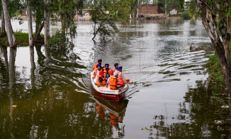Residents at a flood-affected area, at Ajnala in Amritsar district, Punjab