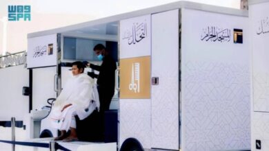 A pilgrim gets a haircut after completing Umrah
