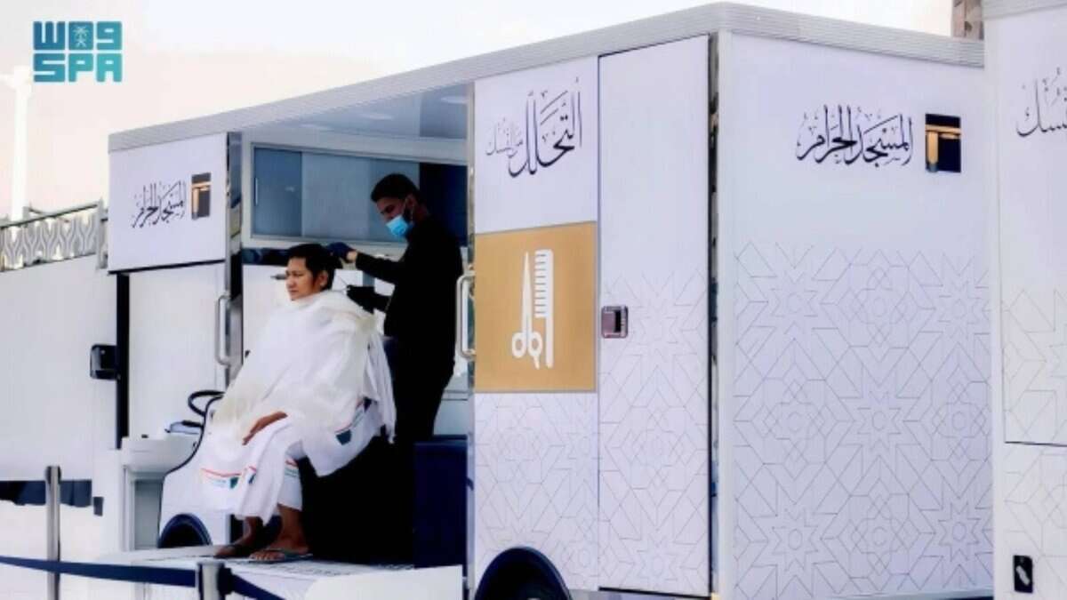 A pilgrim gets a haircut after completing Umrah
