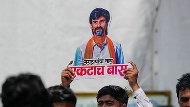 An agitator holds a cutout of activist Manoj Jarange Patil during his indefinite hunger strike demanding reservation for the Maratha community in Mumbai on Tuesday (PTI Photo/Kunal Patil)
