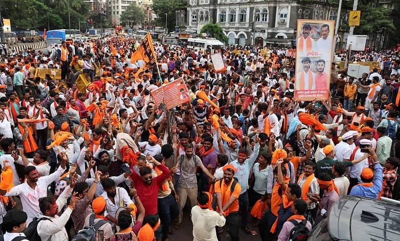 Maratha community members celebrate after the state government accepted most of activist Manoj Jarange Patil's demands, including granting eligible Marathas Kunbi caste certificates which will make them eligible for reservation benefits available to OBCs in Mumbai on Tuesday (PTI Photo)