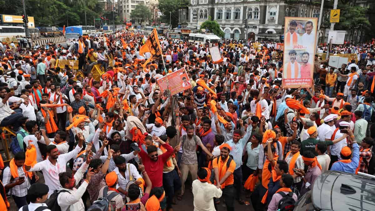 Maratha community members celebrate after the state government accepted most of activist Manoj Jarange Patil's demands, including granting eligible Marathas Kunbi caste certificates which will make them eligible for reservation benefits available to OBCs in Mumbai on Tuesday (PTI Photo)