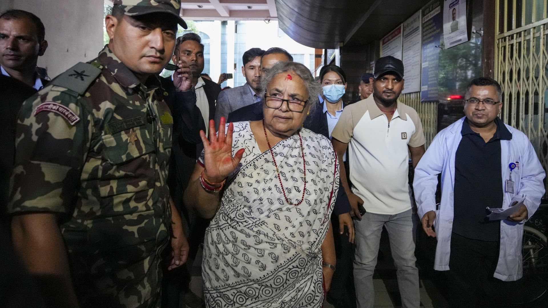 Nepal's interim Prime Minister Sushila Karki, center, arrives to meet the victims of the anti-government protests at a trauma center in Kathmandu, Nepal on Saturday. (PTI Photo/Arun Sharma)