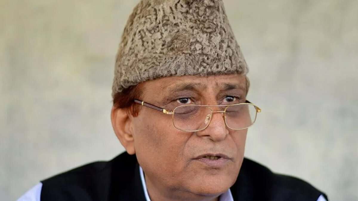 Men wearing glasses and a wool hat, speaking in an interview or speech.