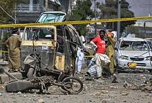 Rescue workers and security officials examine damaged vehicles at the site of a powerful car bombing in Quetta of Pakistan on Tuesday. AP/PTI