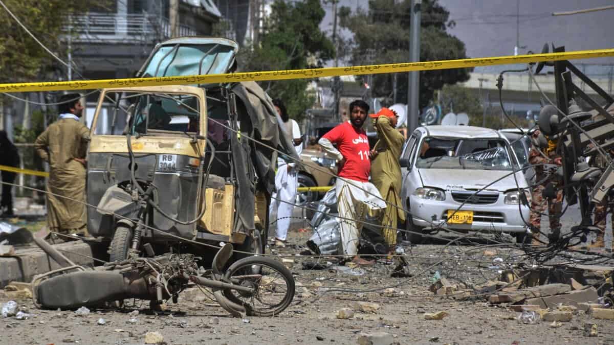 Rescue workers and security officials examine damaged vehicles at the site of a powerful car bombing in Quetta of Pakistan on Tuesday. AP/PTI