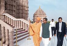 Union Minister Dharmendra Pradhan visits the intricately carved BAPS Hindu temple in Abu Dhabi, guided by a BAPS swami, with other officials walking alongside.