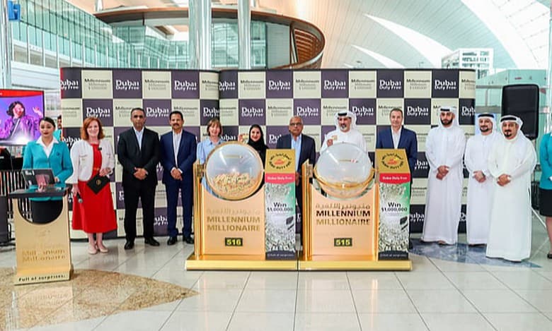 Group photo of the Dubai Duty Free Millennium Millionaire raffle draw at Concourse B, Dubai International Airport, featuring raffle drums, executives in formal attire, and promotional banners, held on September 17, 2025.