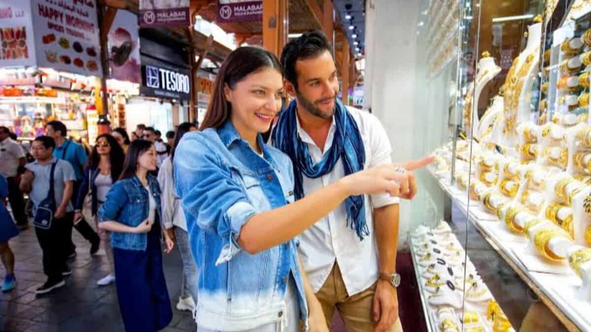 Couple shopping for gold jewellery in Dubai gold souk.