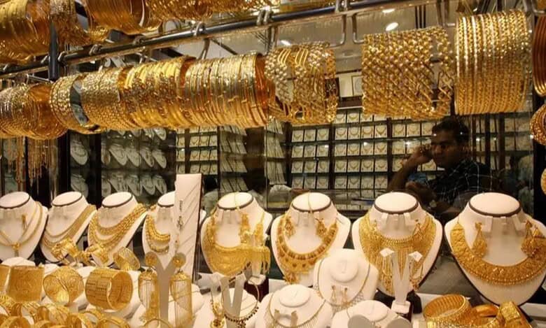 A display of gold jewelry including necklaces, bangles, and bracelets in a shop at the Dubai Gold Souk.