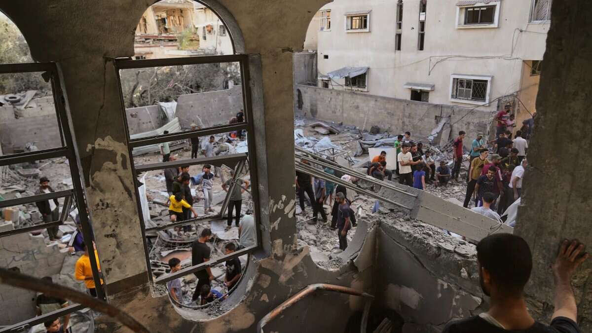 Palestinians gather among rubble after an Israeli airstrike in central Gaza.
