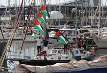 Activists on a boat wave Palestinian flags as part of the Global Sumud Flotilla.