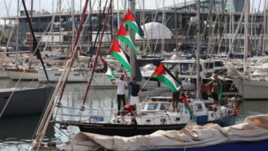 Activists on a boat wave Palestinian flags as part of the Global Sumud Flotilla.