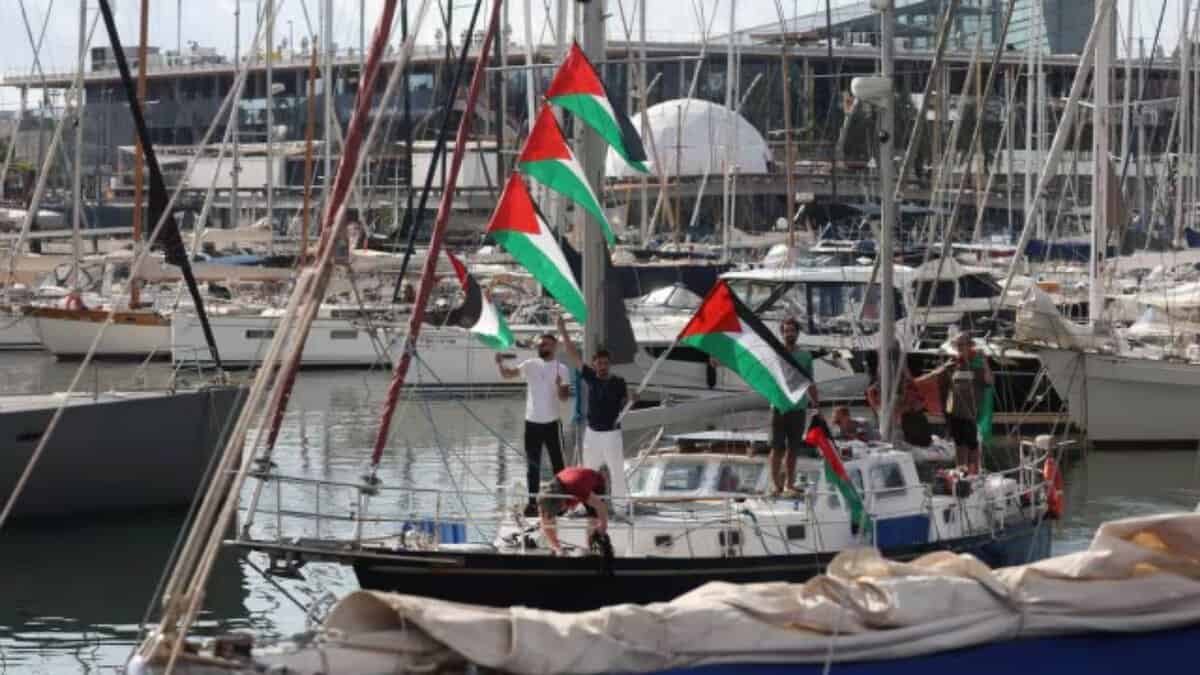 Activists on a boat wave Palestinian flags as part of the Global Sumud Flotilla.