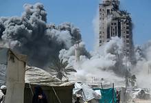 Smoke billows as a high-rise collapses after an Israeli air strike in Gaza City.