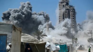 Smoke billows as a high-rise collapses after an Israeli air strike in Gaza City.