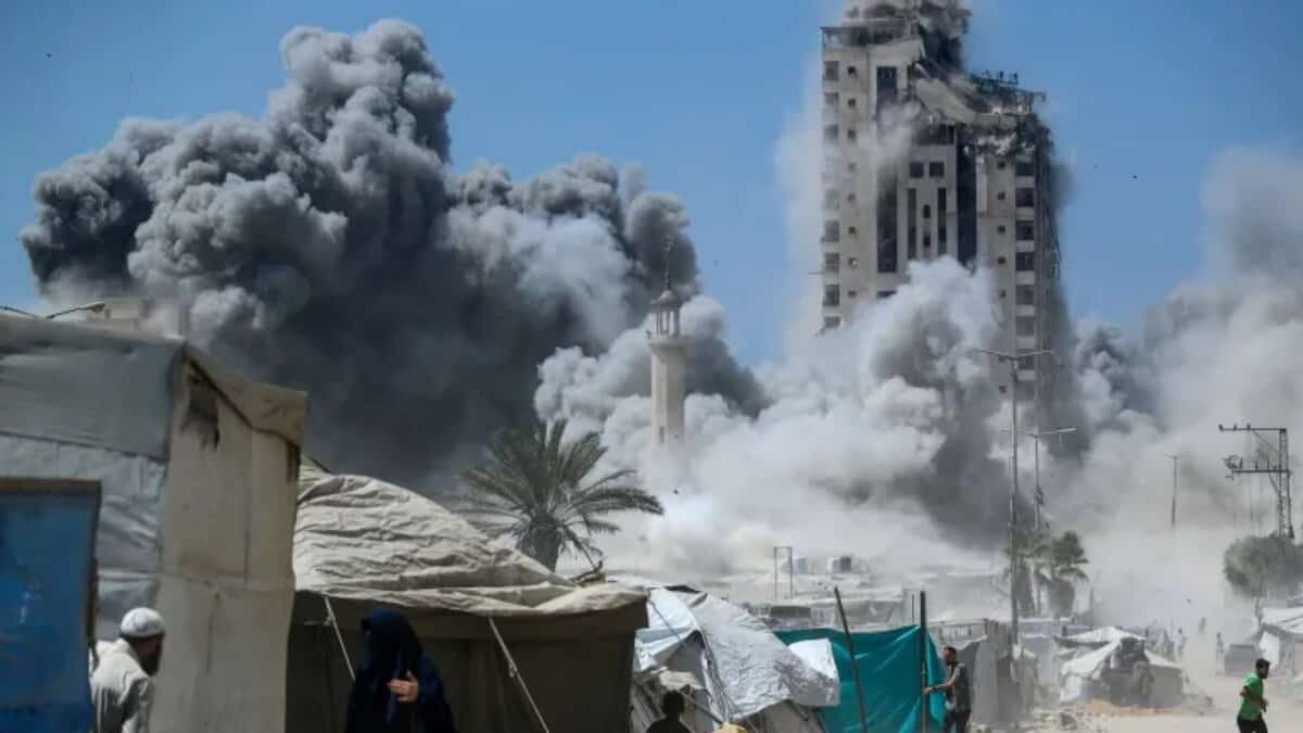 Smoke billows as a high-rise collapses after an Israeli air strike in Gaza City.