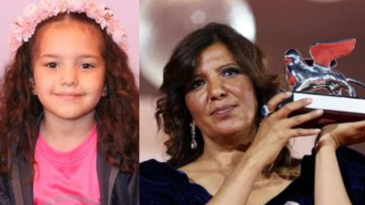 Kaouther Ben Hania with award next to photo of Hind Rajab.