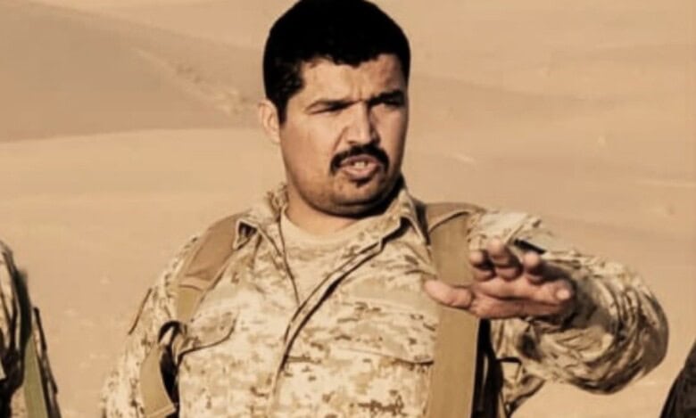 Khaled bin Dowaid Muthanna in military uniform giving instructions in a desert area.