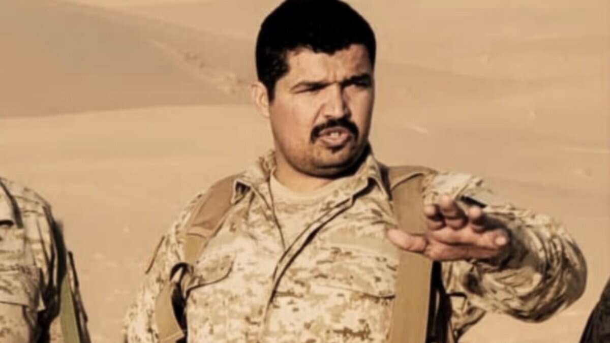 Khaled bin Dowaid Muthanna in military uniform giving instructions in a desert area.