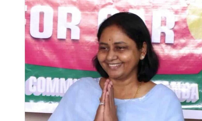 Smiling woman in traditional attire with hands folded in greeting at The Siasat Daily news event.