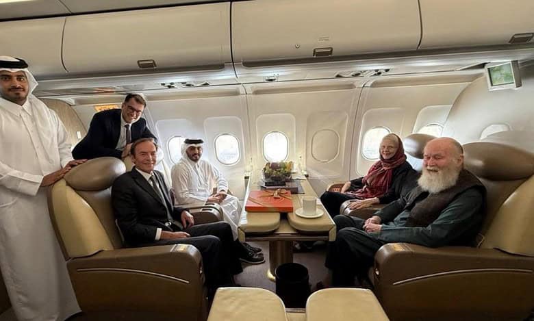 Qatari officials and diplomats sit with British couple Peter and Barbie Reynolds on a plane after their release from Taliban custody in Afghanistan.
