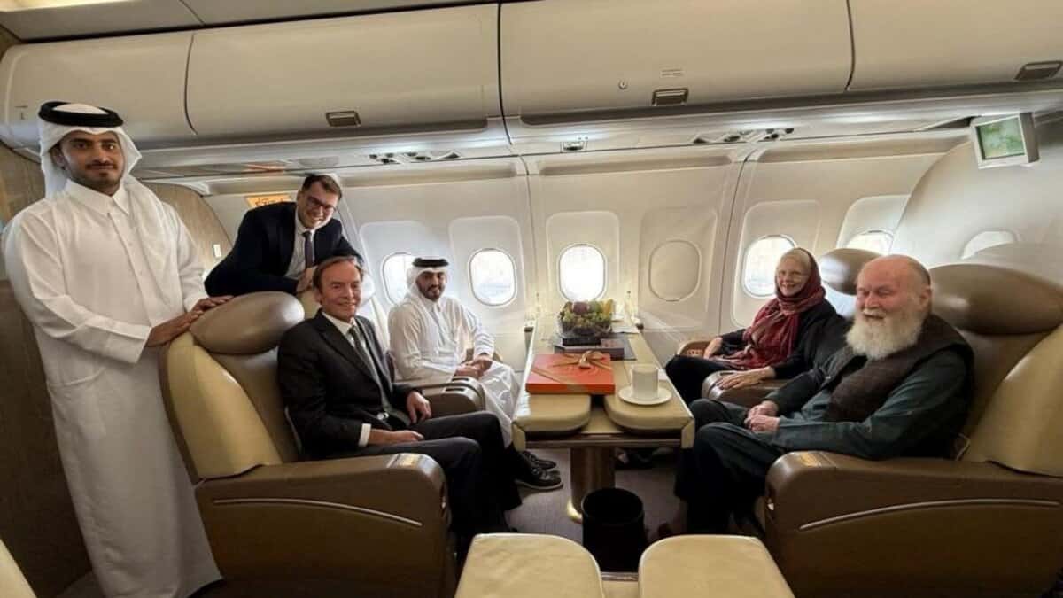 Qatari officials and diplomats sit with British couple Peter and Barbie Reynolds on a plane after their release from Taliban custody in Afghanistan.