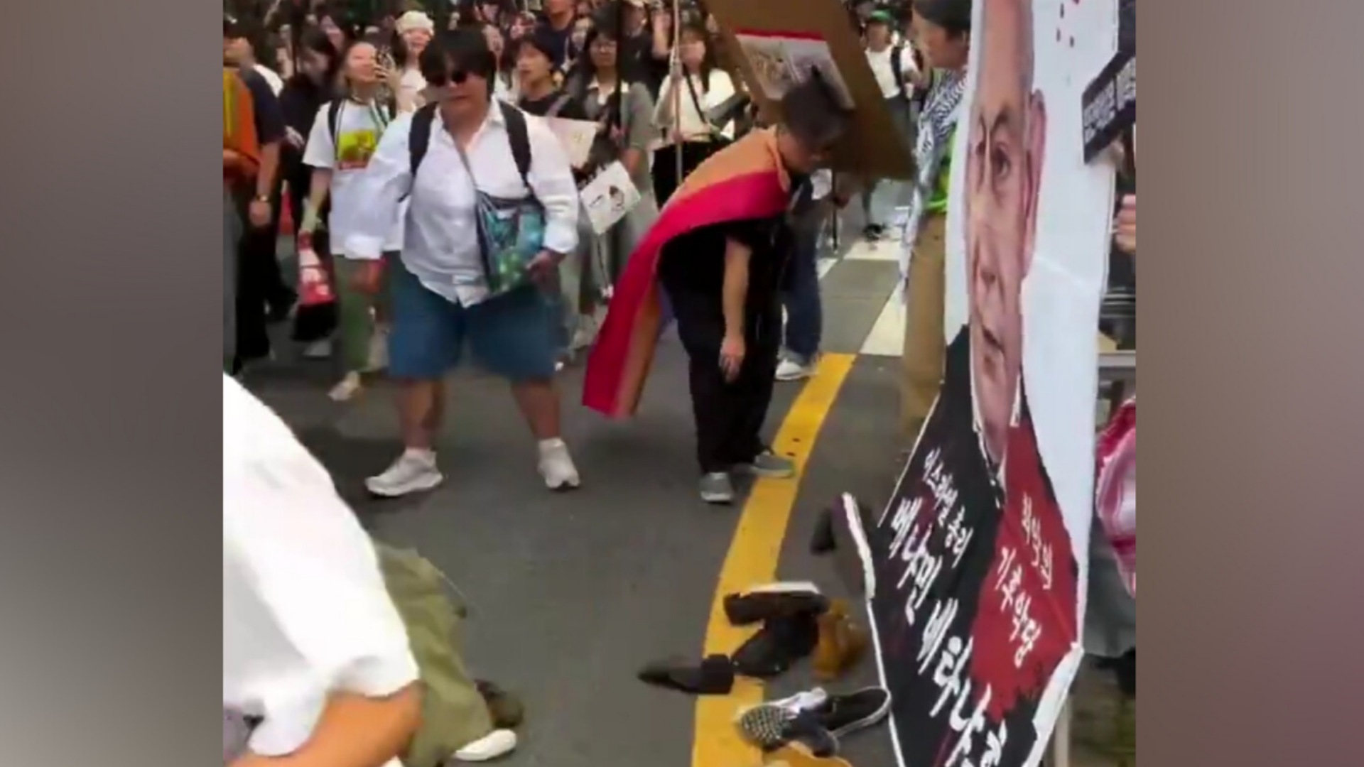 Protesters in Seoul throw shoes at a large poster of Israeli Prime Minister Benjamin Netanyahu during a street demonstration.