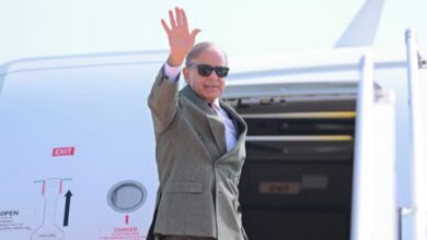 Pakistan Prime Minister Shehbaz Sharif waves before departing for Saudi Arabia.