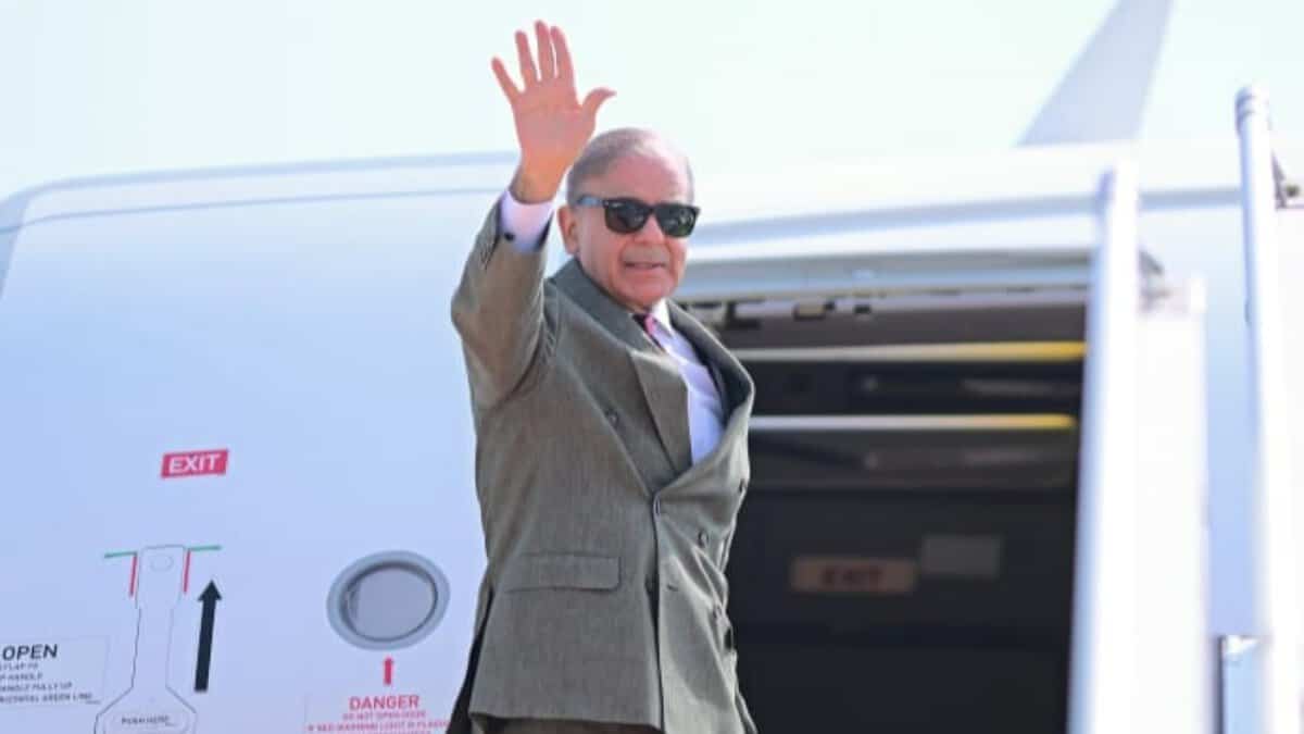 Pakistan Prime Minister Shehbaz Sharif waves before departing for Saudi Arabia.