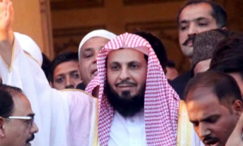 Sheikh Saleh Al-Talib waving among a crowd.