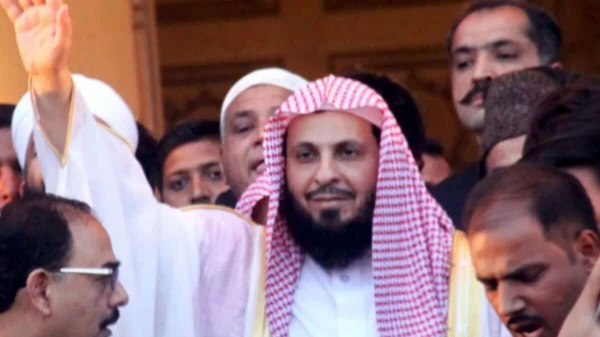 Sheikh Saleh Al-Talib waving among a crowd.