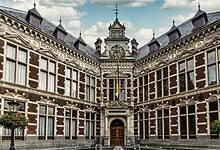 Historic main building of Utrecht University with ornate architecture and symmetrical design.