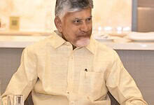 Andhra Pradesh Chief Minister N Chandrababu Naidu seated at a table during his UAE visit.