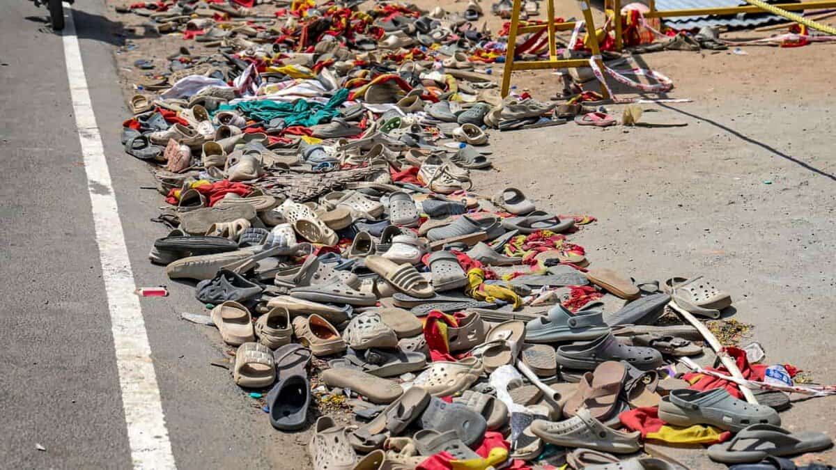 Footwear and other belongings of people lie on a road in the aftermath of stampede in TN
