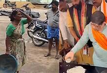 Woman farmer tries desperately to save her paddy which gets washed away in drain at Husnabad agricultural market yard on Thursday, October 30, 2025.