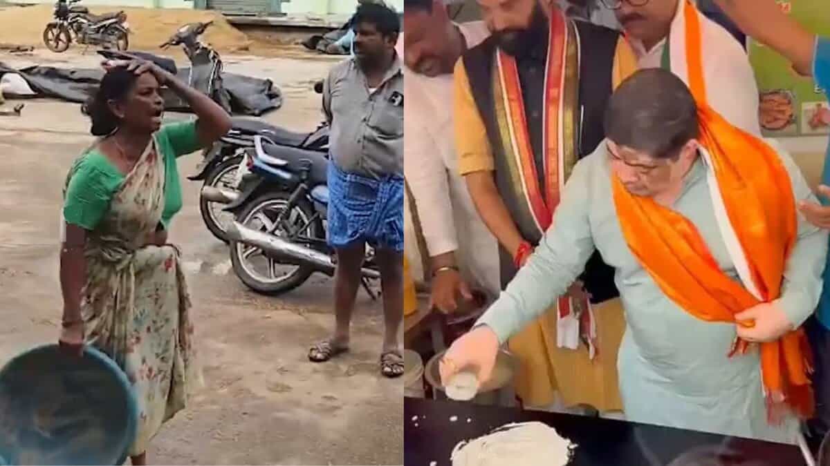 Woman farmer tries desperately to save her paddy which gets washed away in drain at Husnabad agricultural market yard on Thursday, October 30, 2025.