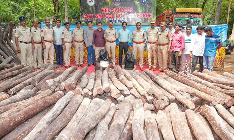 The image shows Red Sanders Anti Smuggling Task Force of Tirupati arresting two inter-state red sanders smugglers in Delhi on October 6, 2025.