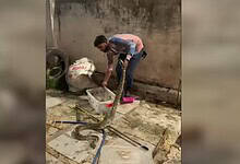 Snake catcher Syed Taqi catches a four-foot Rock Python spotted near City College in Hyderabad on Tuesday