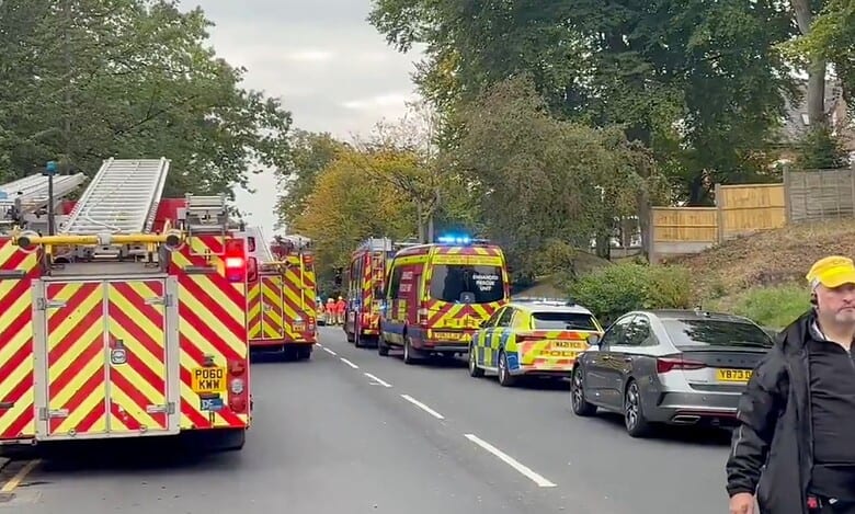 Police vehicles line up at the Synagogue in Manchester after a stabbing incident